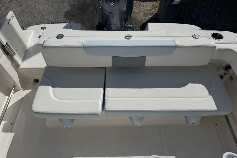 Slide: The Image of 2025 Robalo R222 Explorer boat seating area with white cushioned seats. - 19