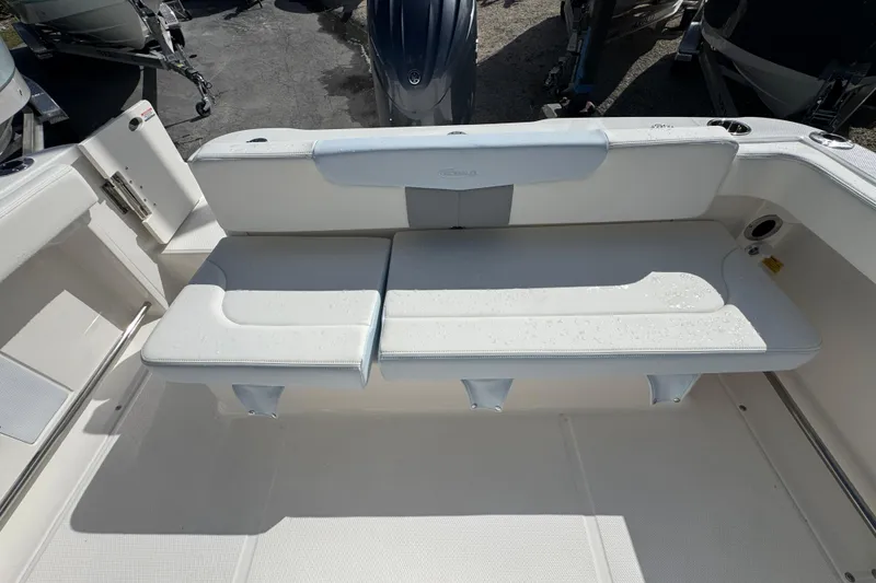 Slide: The Image of 2025 Robalo R222 Explorer boat interior with white cushioned seating. - 20