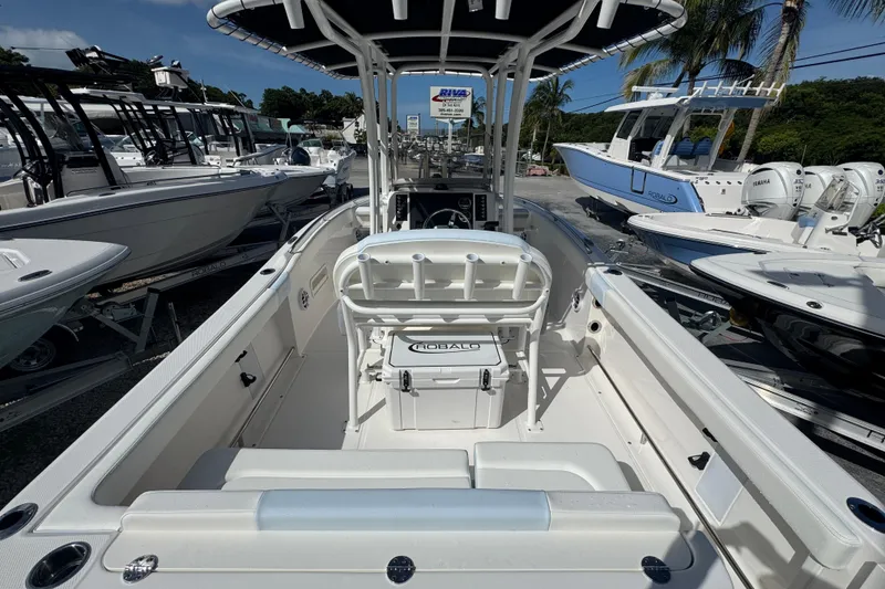 Slide: The Image of 2025 Robalo R222 Explorer boat interior with seating and console, displayed outdoors. - 4