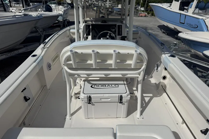 Slide: The Image of 2025 Robalo R222 Explorer boat interior with seating and console, showcasing sleek design. - 5