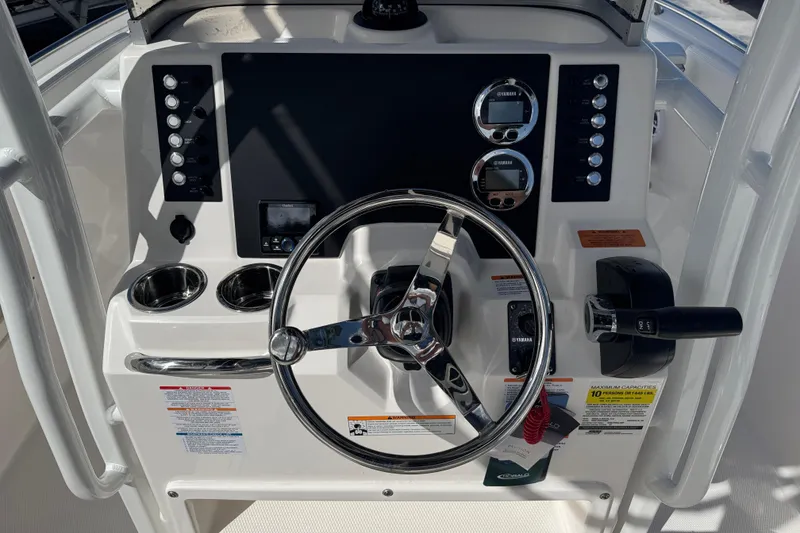 Slide: The Image of 2025 Robalo R222 Explorer boat dashboard with steering wheel and control panel. - 7
