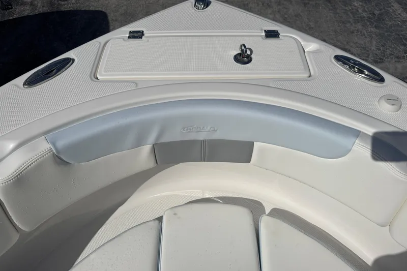 Slide: The Image of 2025 Robalo R222 Explorer boat interior with cushioned seating and storage compartment. - 9