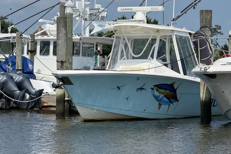 The Image of 2019 Cobia 277 Center Console boat docked in marina, front view. - 0