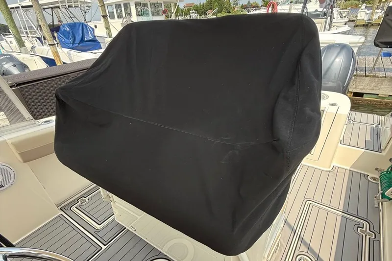 Slide: The Image of 2019 Cobia 277 Center Console with covered helm station at marina. - 13