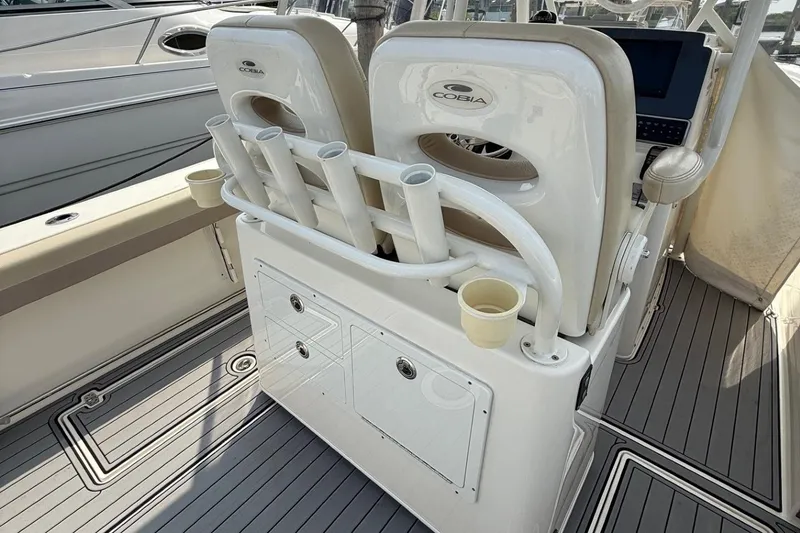 Slide: The Image of 2019 Cobia 277 Center Console boat interior with rod holders and seating. - 15