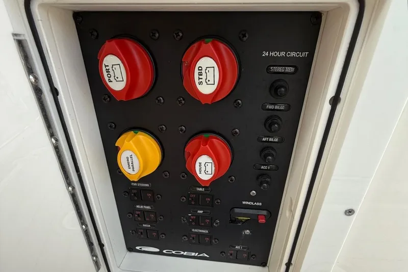 Slide: The Image of 2019 Cobia 277 Center Console boat control panel with switches and circuit breakers. - 17