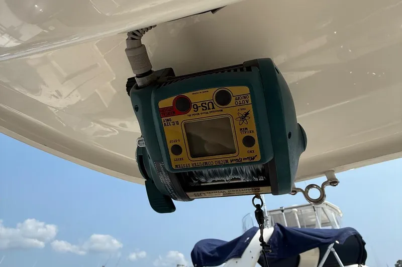 Slide: The Image of 2019 Cobia 277 Center Console with marine equipment under the boat's canopy. - 22