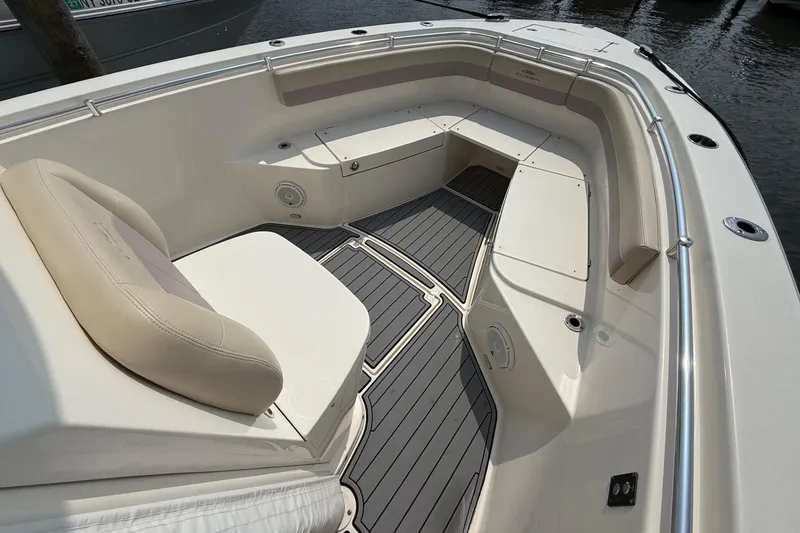 Slide: The Image of 2019 Cobia 277 Center Console boat interior with cushioned seating and sleek design. - 23