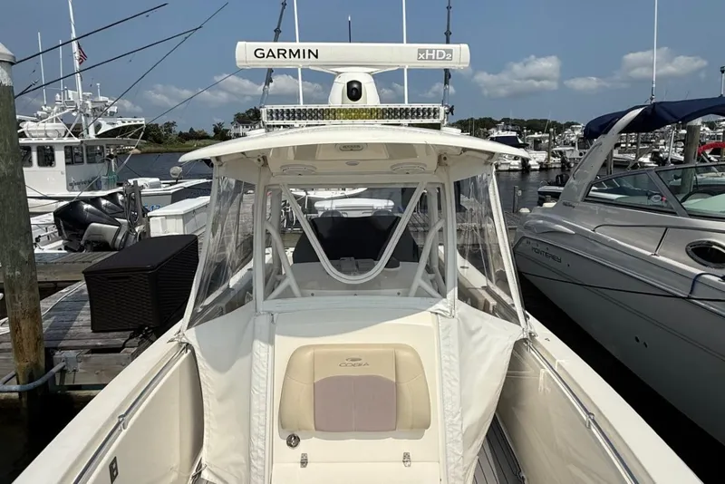 Slide: The Image of 2019 Cobia 277 Center Console boat docked, featuring Garmin xHD2 radar. - 25