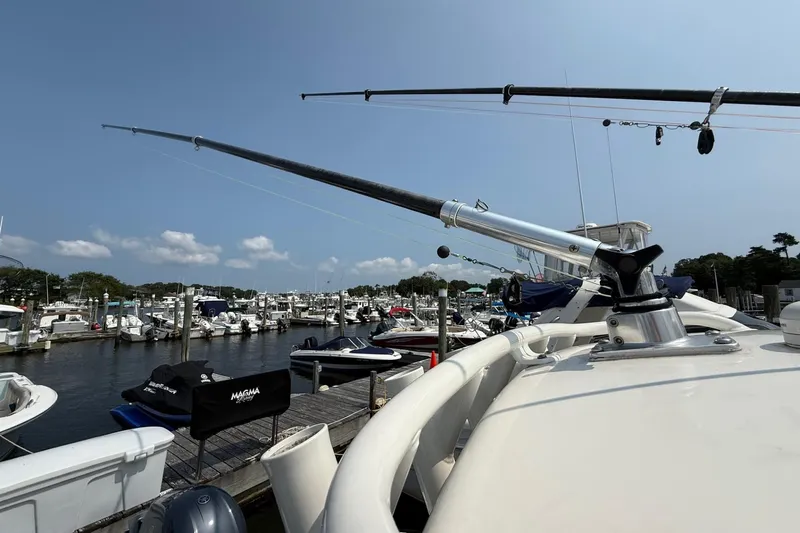 Slide: The Image of 2019 Cobia 277 Center Console boat docked at marina with fishing rods. - 32