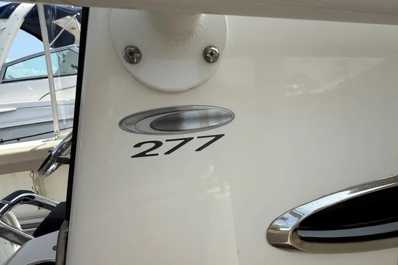 Slide: The Image of 2019 Cobia 277 Center Console boat emblem and model number detail. - 35