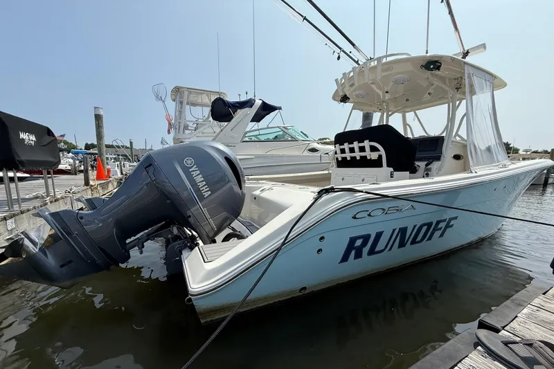 Slide: The Image of 2019 Cobia 277 Center Console boat docked with Yamaha engine. - 4