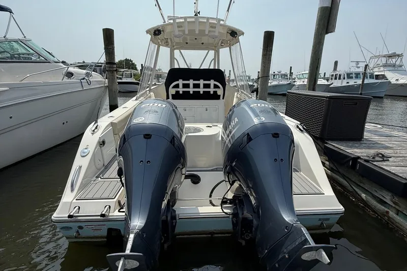 Slide: The Image of 2019 Cobia 277 Center Console boat with dual Yamaha engines docked at marina. - 6