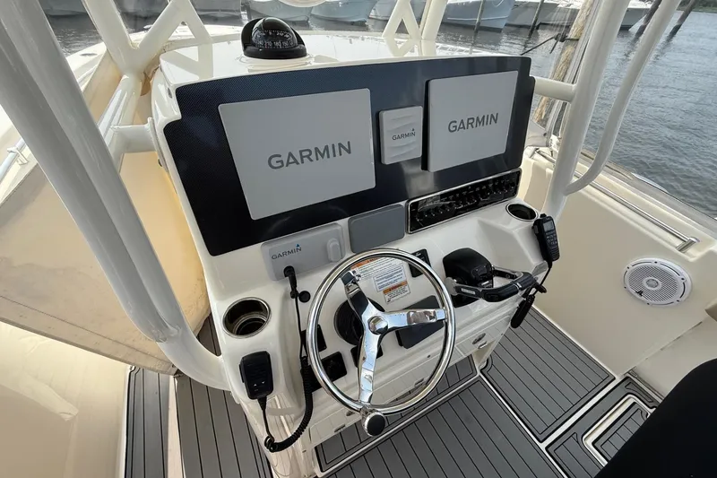 Slide: The Image of 2019 Cobia 277 Center Console helm with Garmin displays and steering wheel. - 9