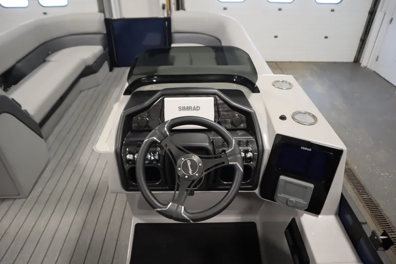 Slide: The Image of 2025 Bentley Pontoons Elite 253 Admiral Tri-toon dashboard with steering wheel and controls. - 22