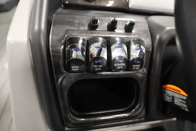 Slide: The Image of Control panel of 2025 Bentley Pontoons Elite 253 Admiral Tri-toon with labeled switches. - 26