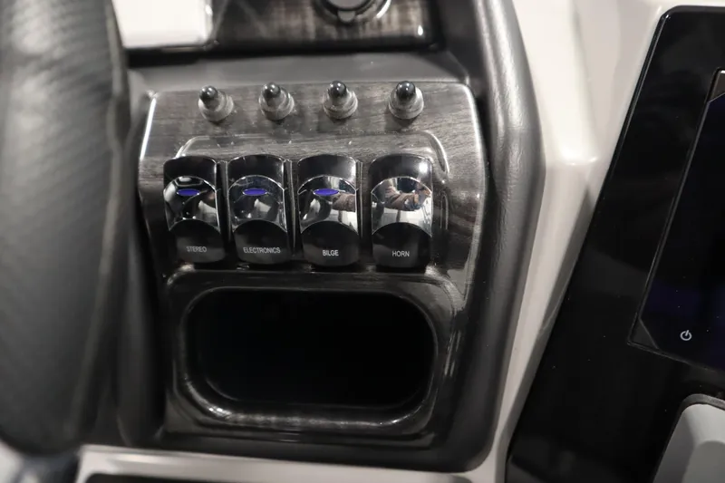 Slide: The Image of Control panel of 2025 Bentley Pontoons Elite 253 Admiral Tri-toon with labeled switches. - 27