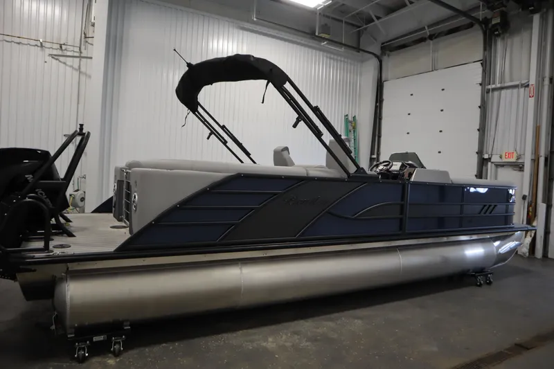Slide: The Image of 2025 Bentley Pontoons Elite 253 Admiral Tri-toon in a garage setting. - 3