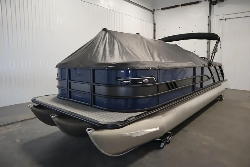 Slide: The Image of 2025 Bentley Pontoons Elite 253 Admiral Tri-toon with cover in a garage setting. - 49