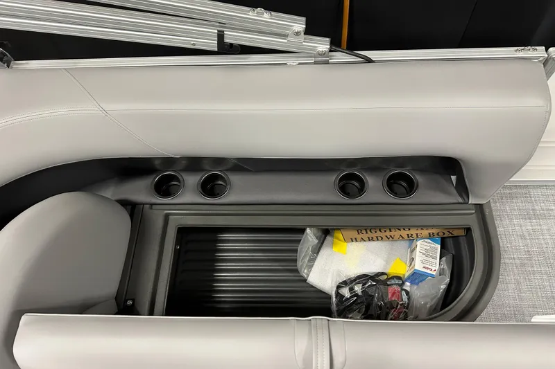 Slide: The Image of Interior of 2026 Sun Tracker Party Barge 16 DLX with storage compartment and cup holders. - 13