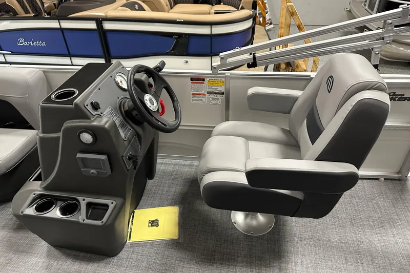Slide: The Image of 2026 Sun Tracker Party Barge 16 DLX helm with steering wheel and captain's chair. - 15