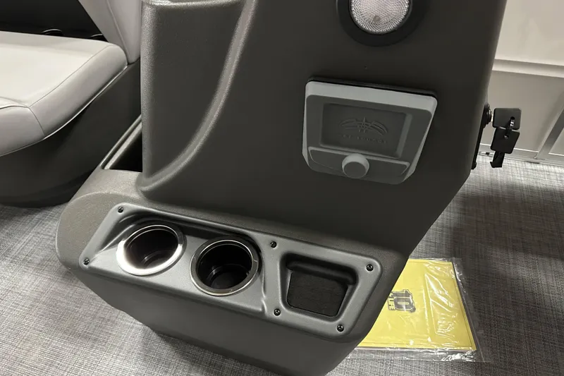 Slide: The Image of 2026 Sun Tracker Party Barge 16 DLX interior with cup holders and storage compartment. - 16
