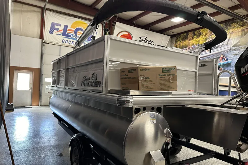 Slide: The Image of 2026 Sun Tracker Party Barge 16 DLX pontoon boat in showroom, side view. - 4