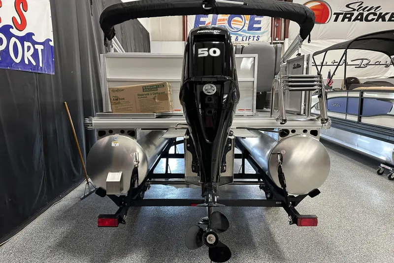 Slide: The Image of 2026 Sun Tracker Party Barge 16 DLX with Mercury 50 engine in showroom. - 5