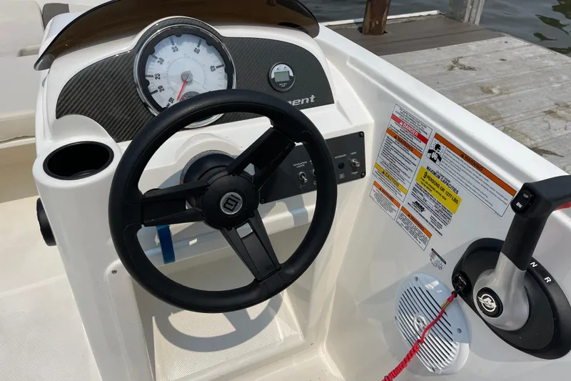Slide: The Image of 2020 Bayliner Element boat dashboard with steering wheel, speedometer, and control panel. - 15