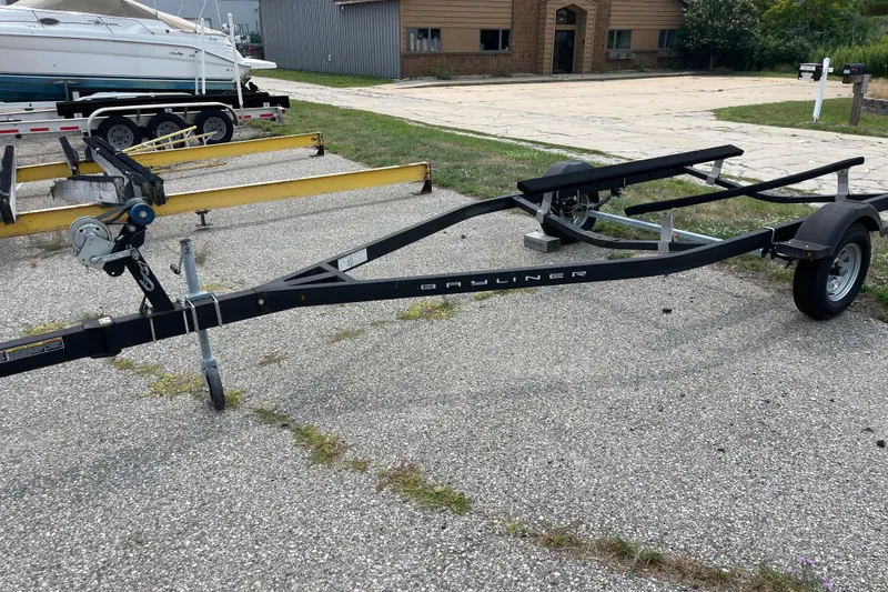 Slide: The Image of 2020 Bayliner Element boat trailer on paved surface near other trailers. - 21