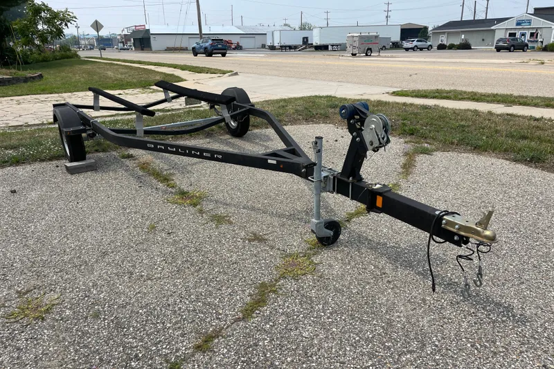 Slide: The Image of 2020 Bayliner Element boat trailer parked on a paved surface. - 23