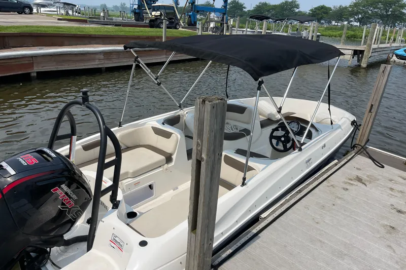 Slide: The Image of 2020 Bayliner Element boat docked with canopy and Mercury Pro XS engine. - 4