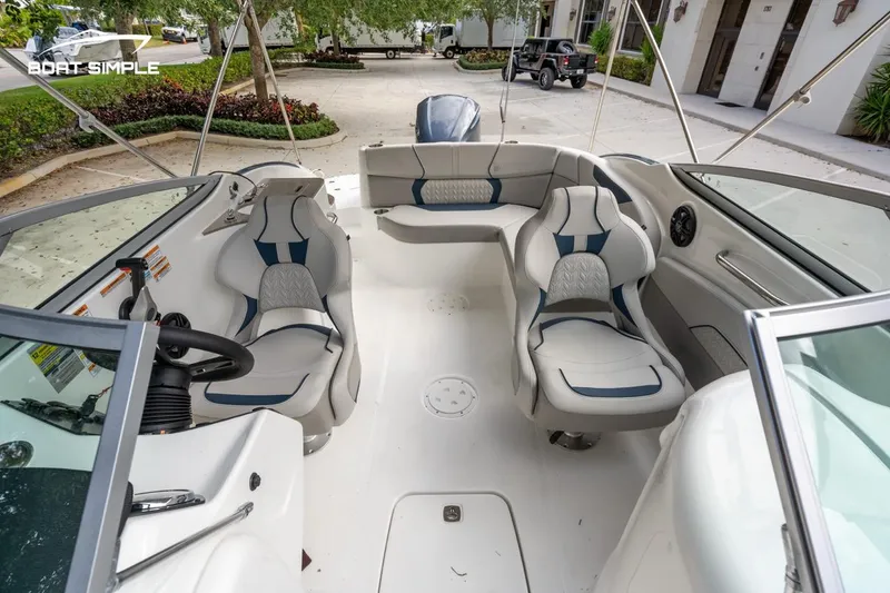 Slide: The Image of 2025 Hurricane SunDeck 2400 OB boat interior with modern seating and steering wheel. - 14