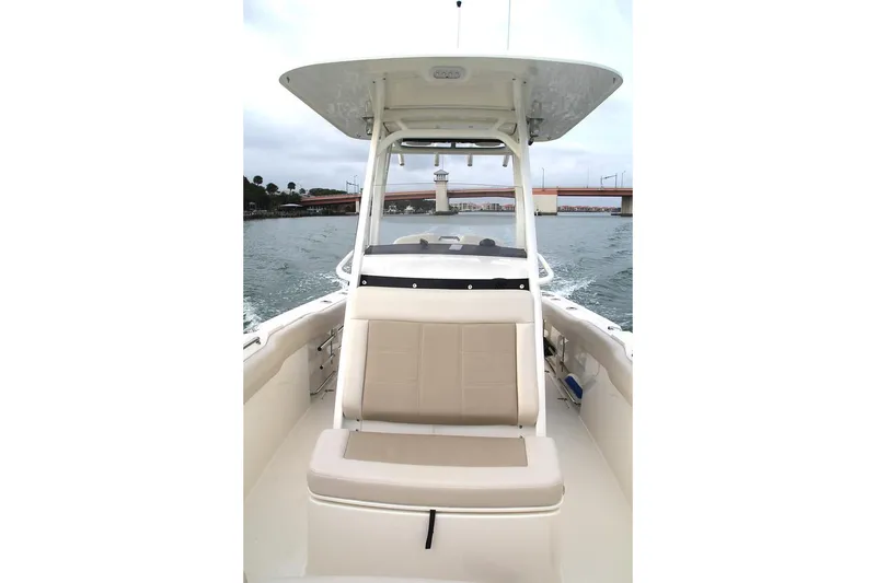 Slide: The Image of 2026 Boston Whaler 230 Outrage dashboard with Simrad electronics and steering wheel. - 9