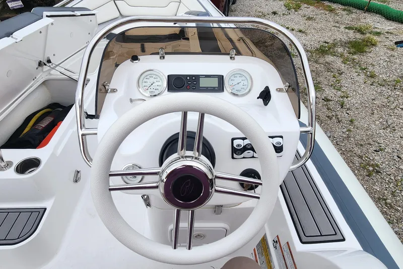 Slide: The Image of 2022 Walker Bay Generation 525 DLX boat dashboard with steering wheel and gauges. - 10