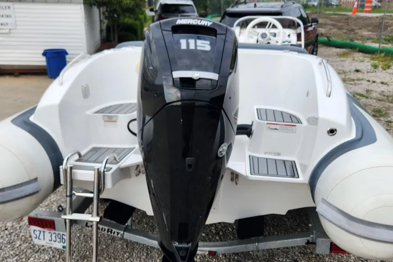 Slide: The Image of 2022 Walker Bay Generation 525 DLX with Mercury 115 outboard engine, rear view. - 12