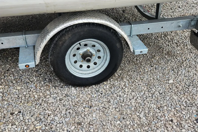 Slide: The Image of Trailer wheel of 2022 Walker Bay Generation 525 DLX on gravel surface. - 6