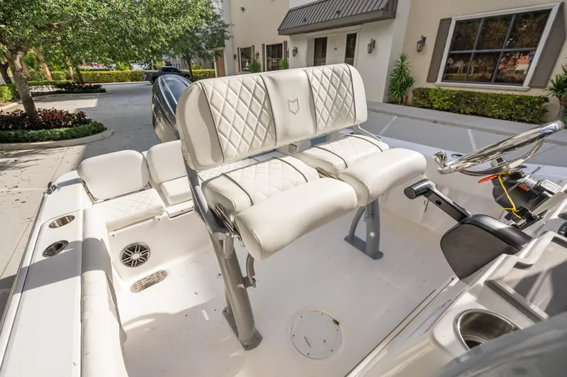 Slide: The Image of 2025 Sea Fox 228 Commander boat interior with white seating and steering console. - 14