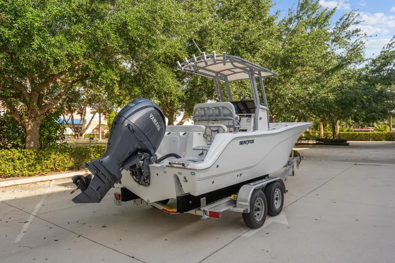 Slide: The Image of 2025 Sea Fox 228 Commander boat on trailer, parked outdoors with Yamaha engine. - 5