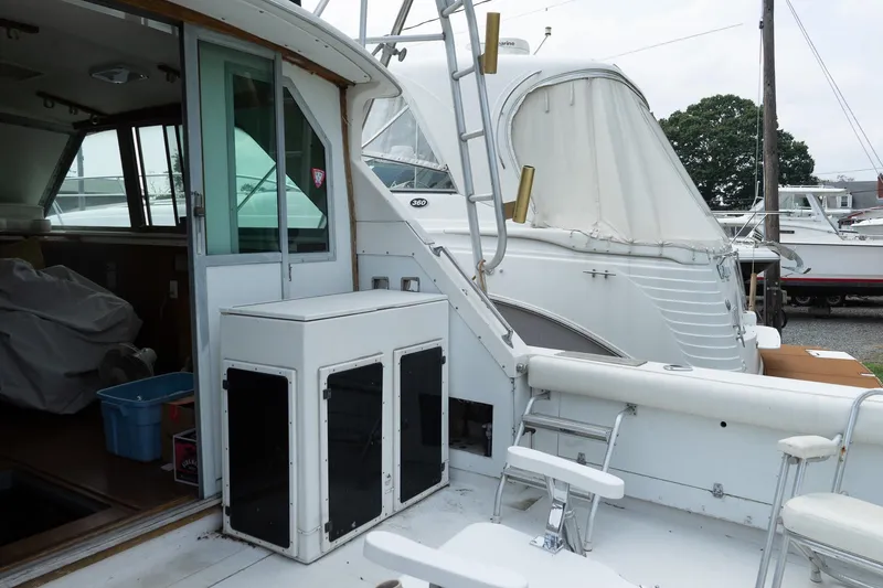 Slide: The Image of 1978 Bertram 35 Flybridge Sportfish boat interior with seating and storage, docked at marina. - 16