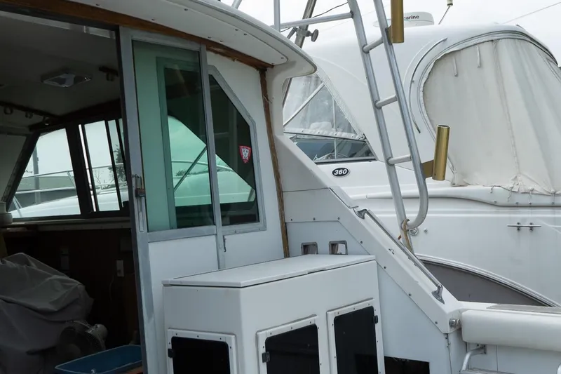 Slide: The Image of 1978 Bertram 35 Flybridge Sportfish boat with ladder and cabin view. - 17