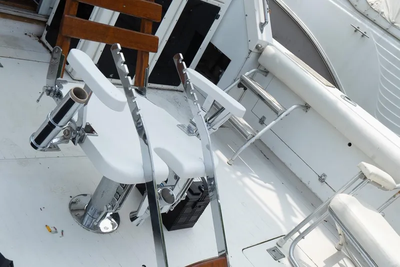 Slide: The Image of 1978 Bertram 35 Flybridge Sportfish cockpit with fishing chair and rod holders. - 19
