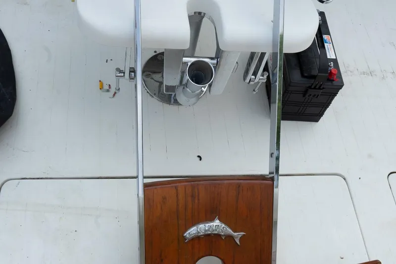 Slide: The Image of 1978 Bertram 35 Flybridge Sportfish deck with fishing chair and battery. - 21