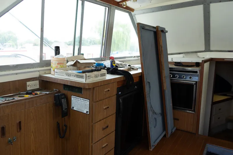 Slide: The Image of Interior of a 1978 Bertram 35 Flybridge Sportfish boat with kitchen area and equipment. - 23