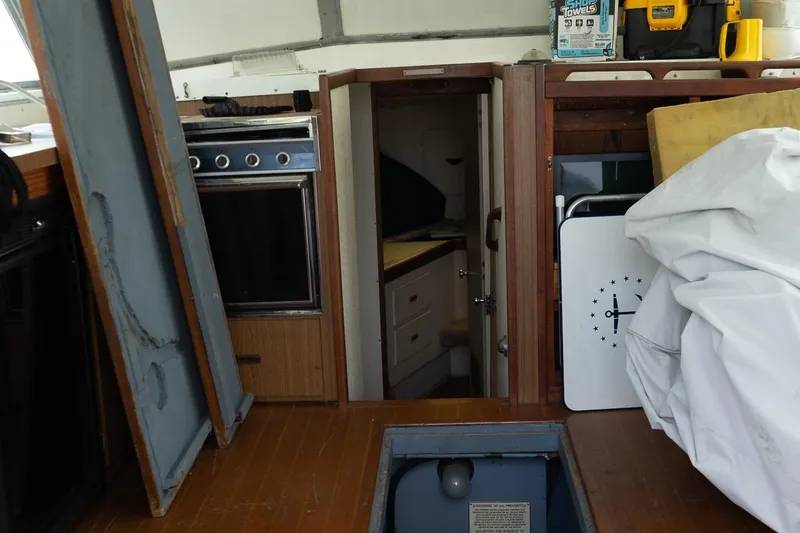 Slide: The Image of 1978 Bertram 35 Flybridge Sportfish interior with kitchen and storage area. - 26
