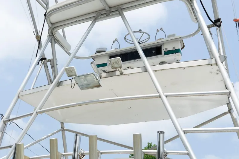 Slide: The Image of 1978 Bertram 35 Flybridge Sportfish helm station with steering wheel and controls. - 3