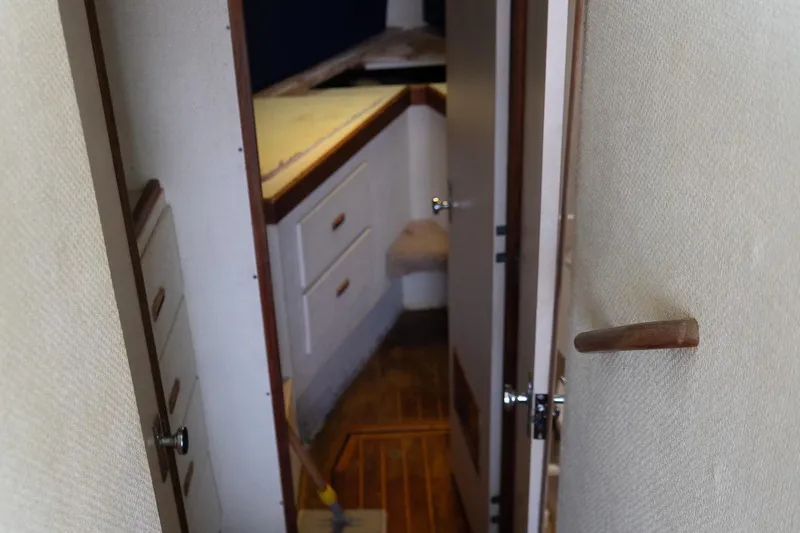 Slide: The Image of Interior view of 1978 Bertram 35 Flybridge Sportfish, featuring hallway and cabinetry. - 31