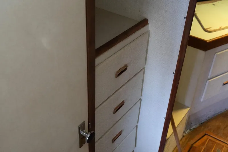 Slide: The Image of 1978 Bertram 35 Flybridge Sportfish interior with wooden drawers and cabinetry. - 32