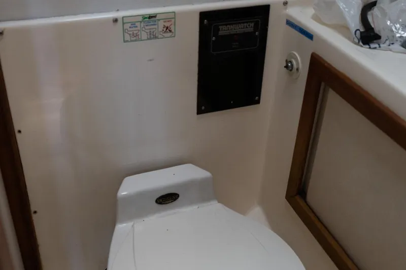 Slide: The Image of 1978 Bertram 35 Flybridge Sportfish boat bathroom with toilet and control panel. - 34