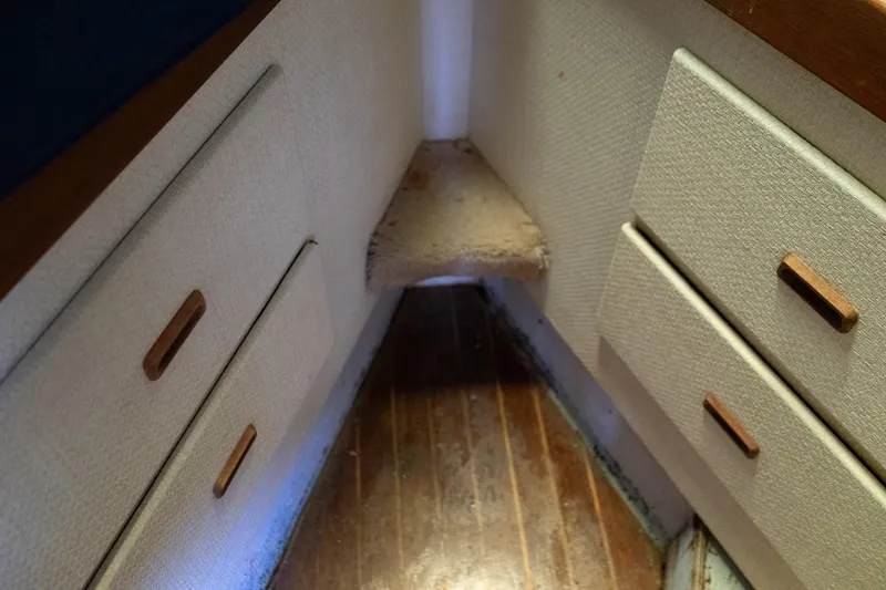 Slide: The Image of Interior of 1978 Bertram 35 Flybridge Sportfish with wooden drawers and carpeted step. - 37